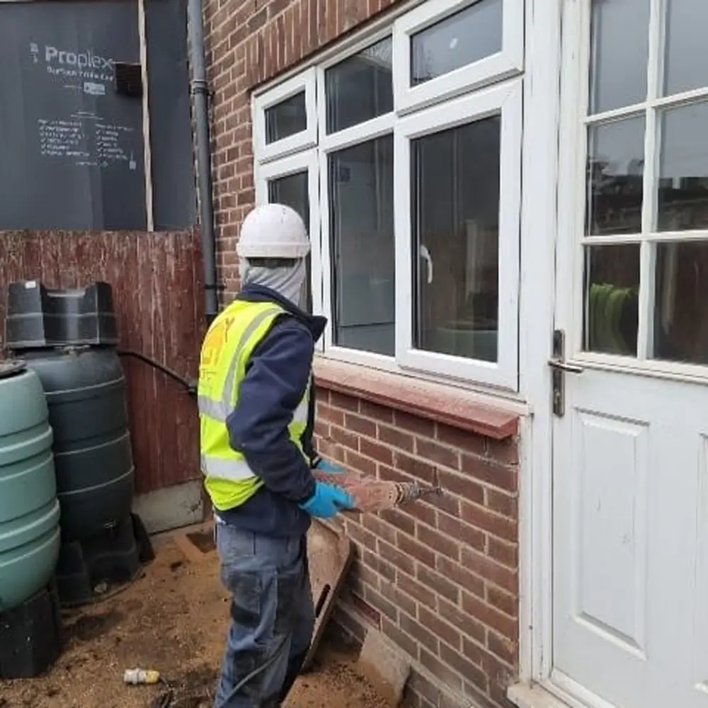 worker doing cavity wall insulation